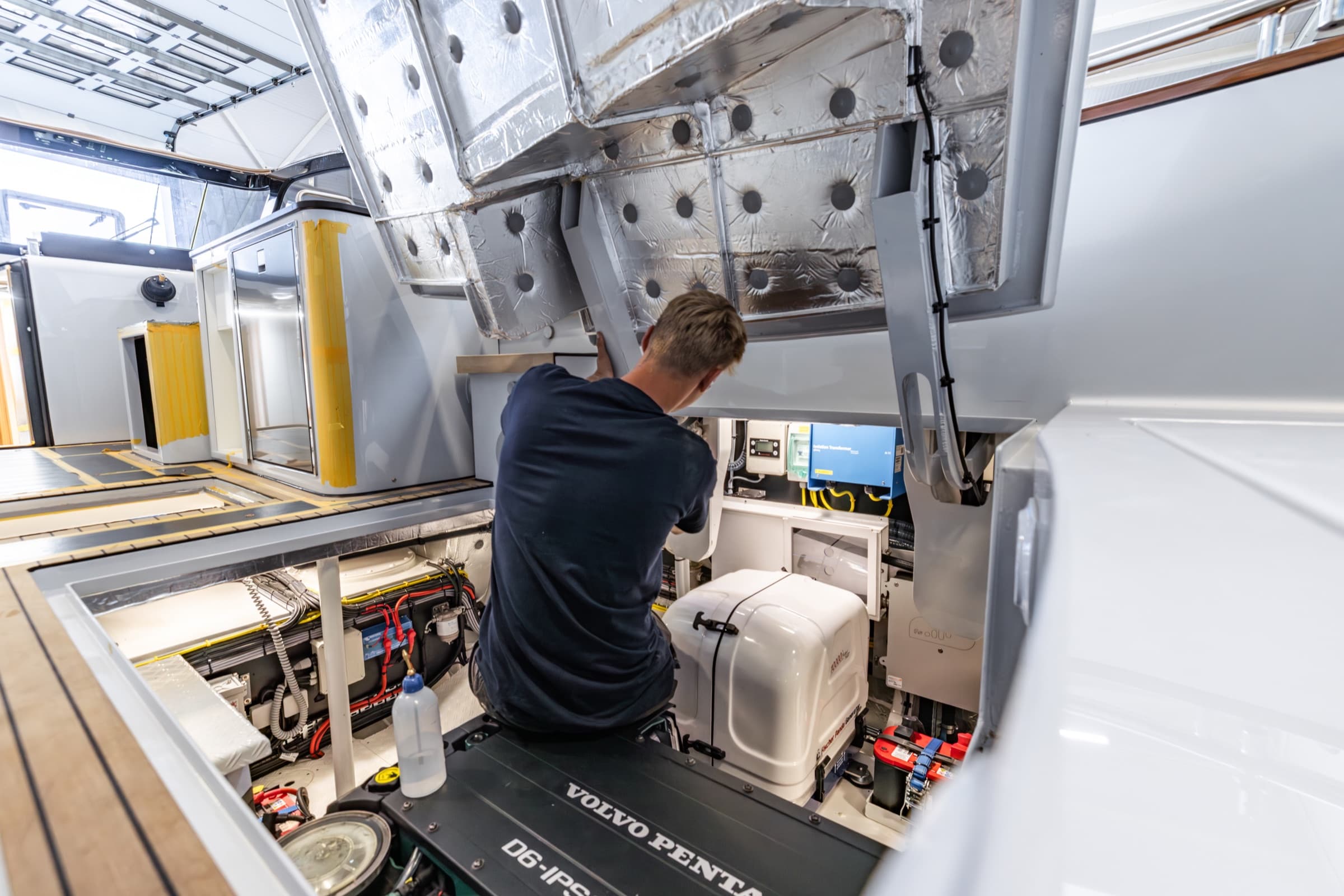 Technician at work in a yacht's engine room