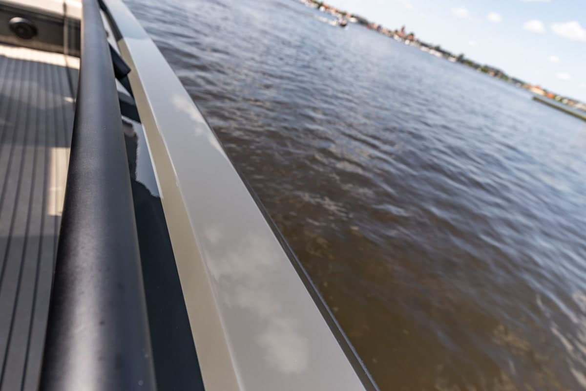 Glossy hull and rail above the water