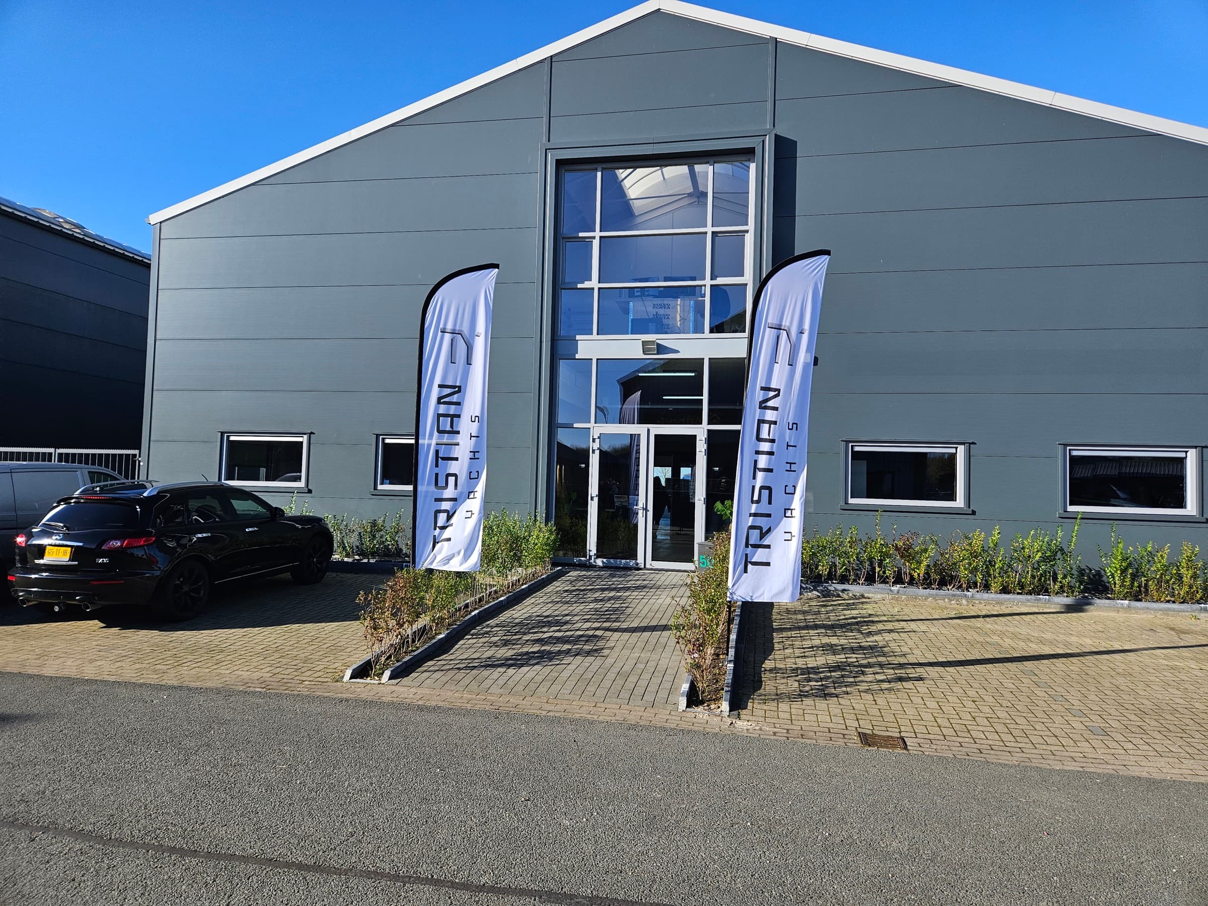 Tristian Yachts yard building with flags at the entrance
