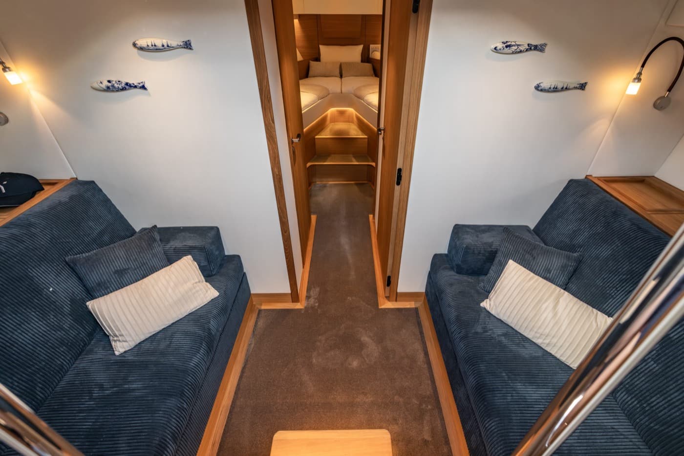 Saloon with two sofas and a view through to the cabin